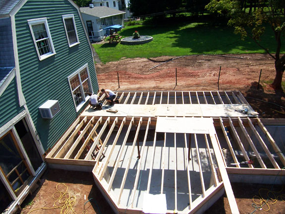 Contractors work on building subfloor